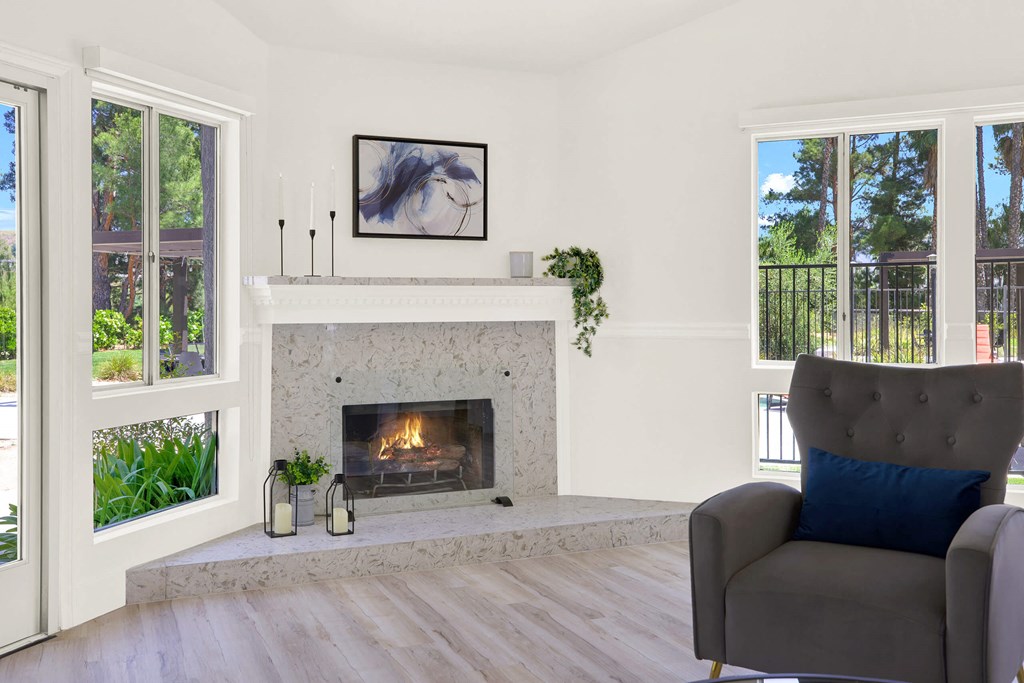 a living room with a fireplace and a chair at Monterra Ridge Apartments, California,91351