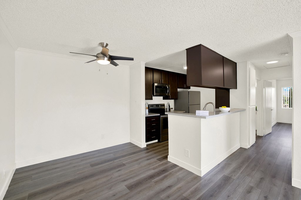 an open kitchen and living room with a ceiling fan at Monterra Ridge Apartments, California,91351