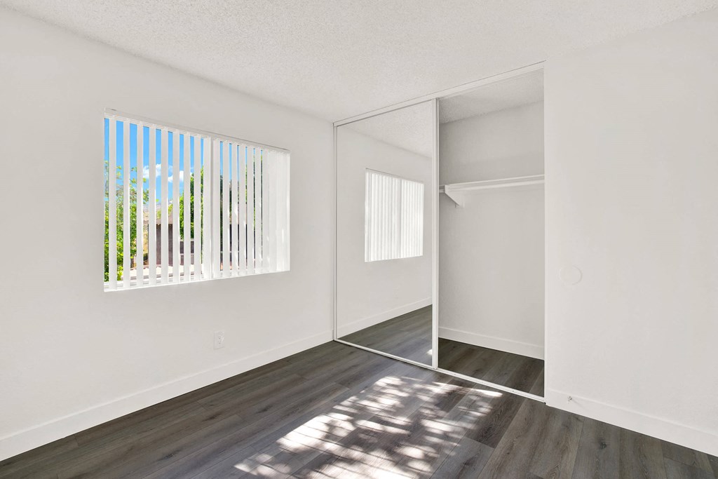 an empty room with a window and wood floors at Monterra Ridge Apartments, California,91351