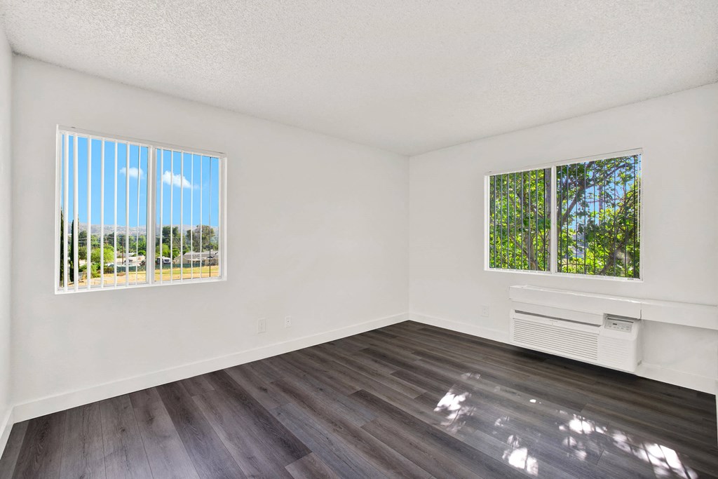 an empty living room with wood flooring and a window at Monterra Ridge Apartments, California,91351