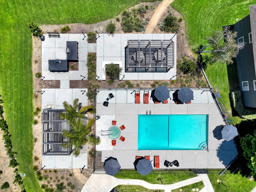 arial view of the pool and yard of a house with a blue pool at Monterra Ridge Apartments, Canyon Country ,91351