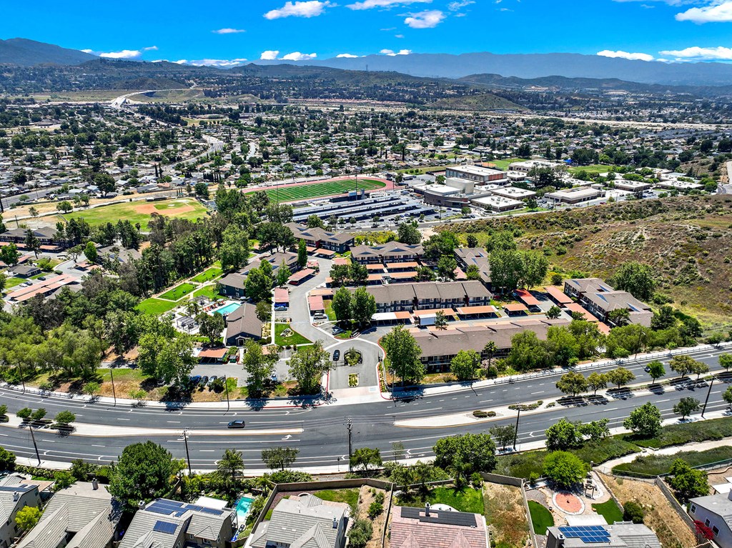 an aerial view of a parking lot with houses and trees at Monterra Ridge Apartments, California,91351