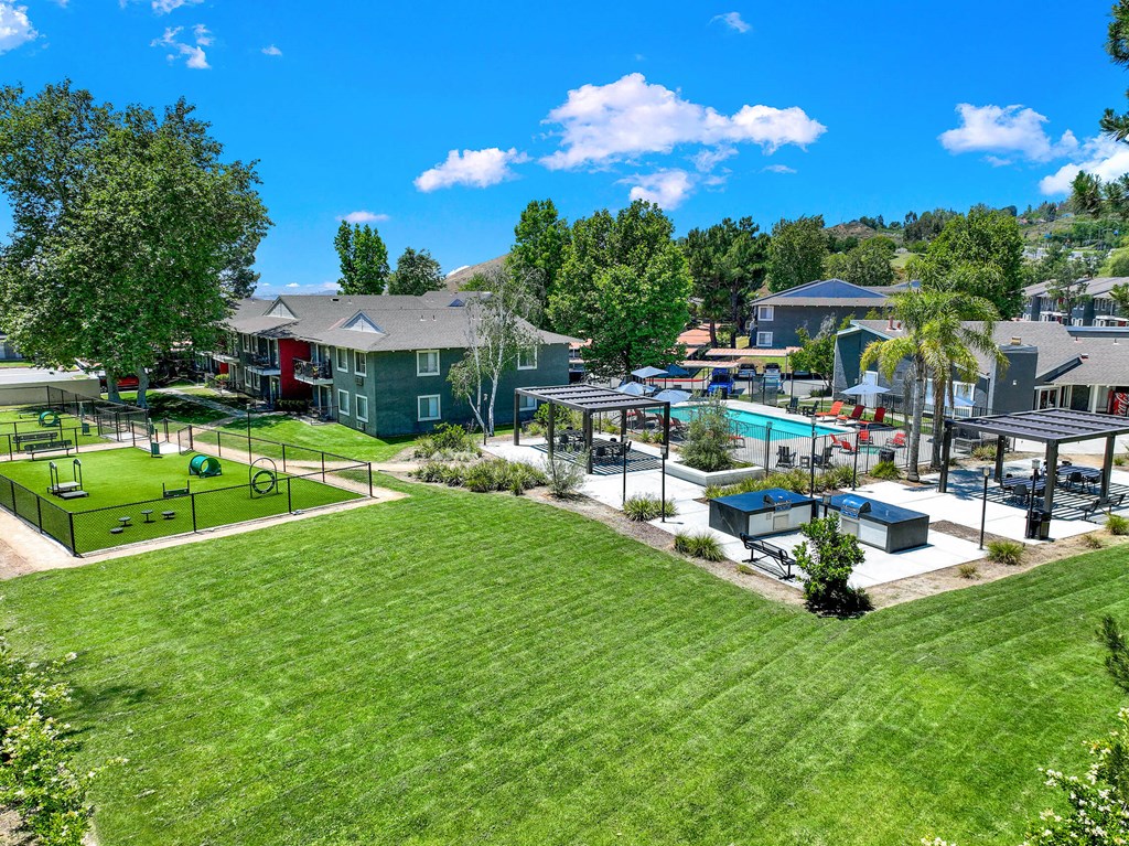 a park with a playground and a pool in a community at Monterra Ridge Apartments, Canyon Country, California