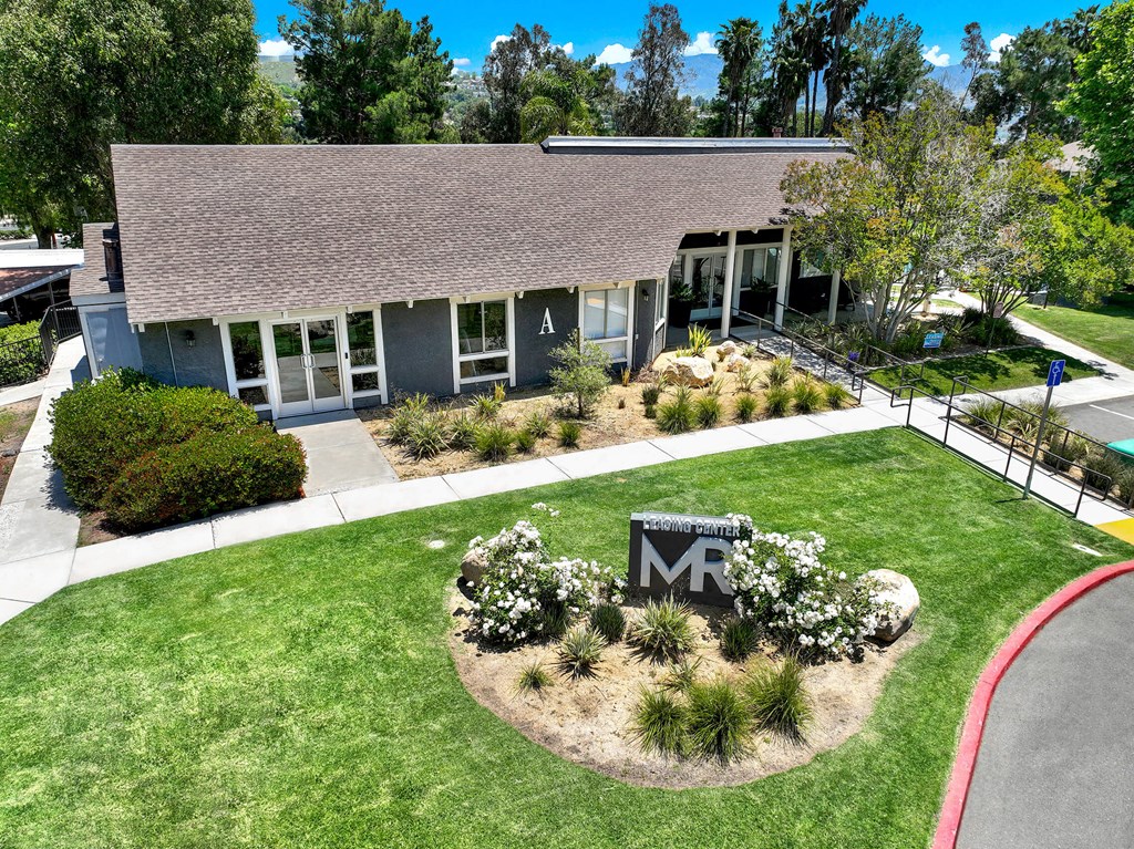 the front of a building with a lawn and a sign in front of it at Monterra Ridge Apartments, Canyon Country, California