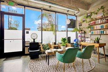 a living room with chairs and a table in front of a window at the perch, Los Angeles, California