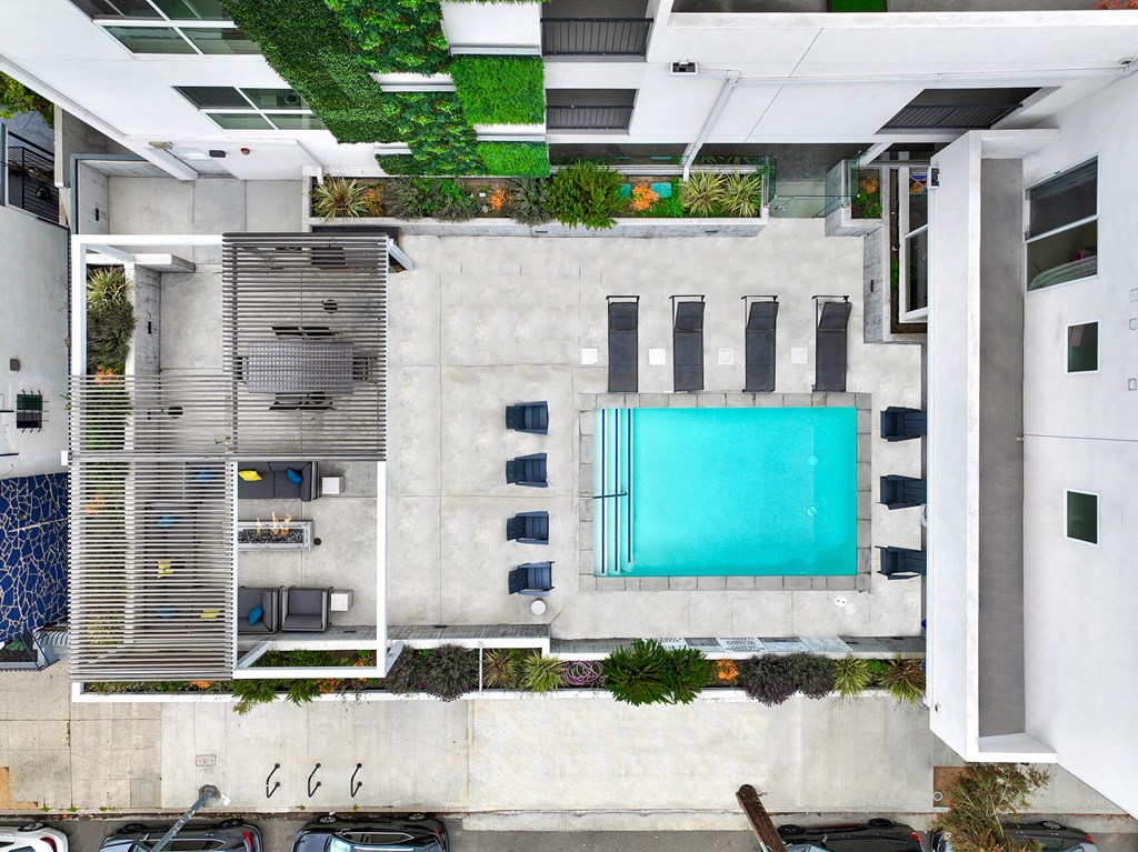 an aerial view of a building with a swimming pool