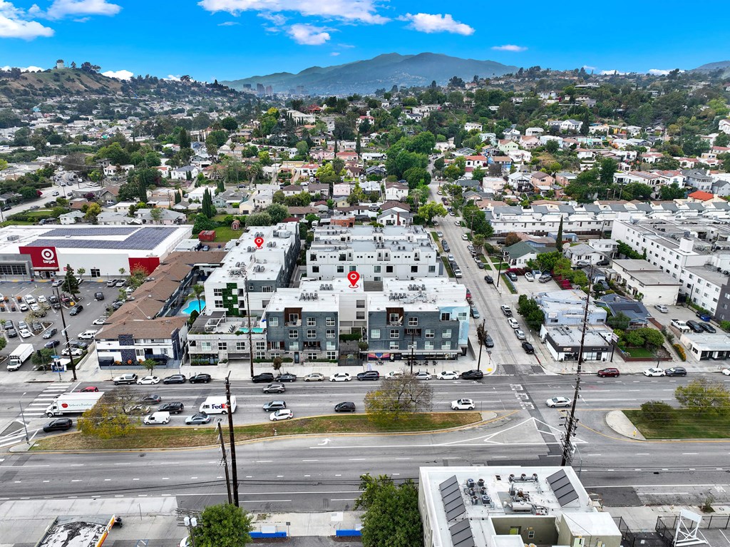 an aerial view of a city with a mountain in the background