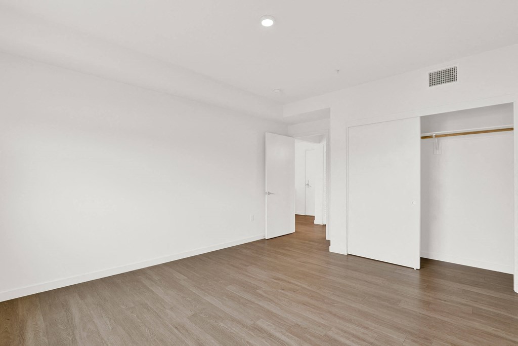 a living room with white walls and wood floors