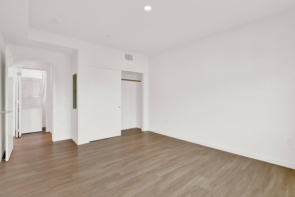 a living room with white walls and wood floors