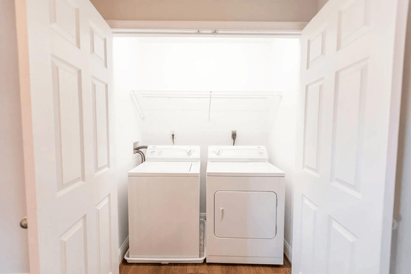 A white bathroom with two sinks and a window.