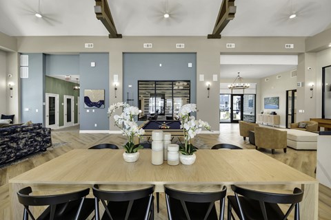 A dining room with a wooden table and chairs.
