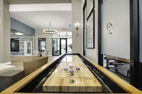 A shiny wooden table with numbers 2, 3 and 4 on it is in the middle of a room.