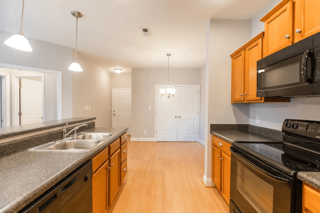 full kitchen with granite counter tops and stainless steel appliances