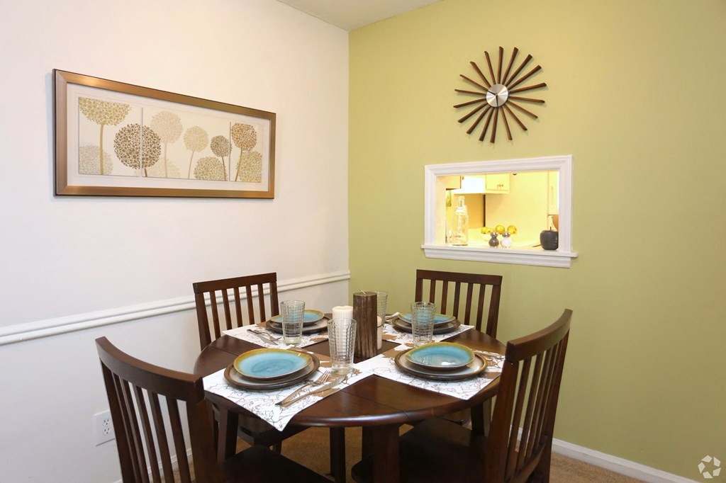 a dining room with a table and chairs