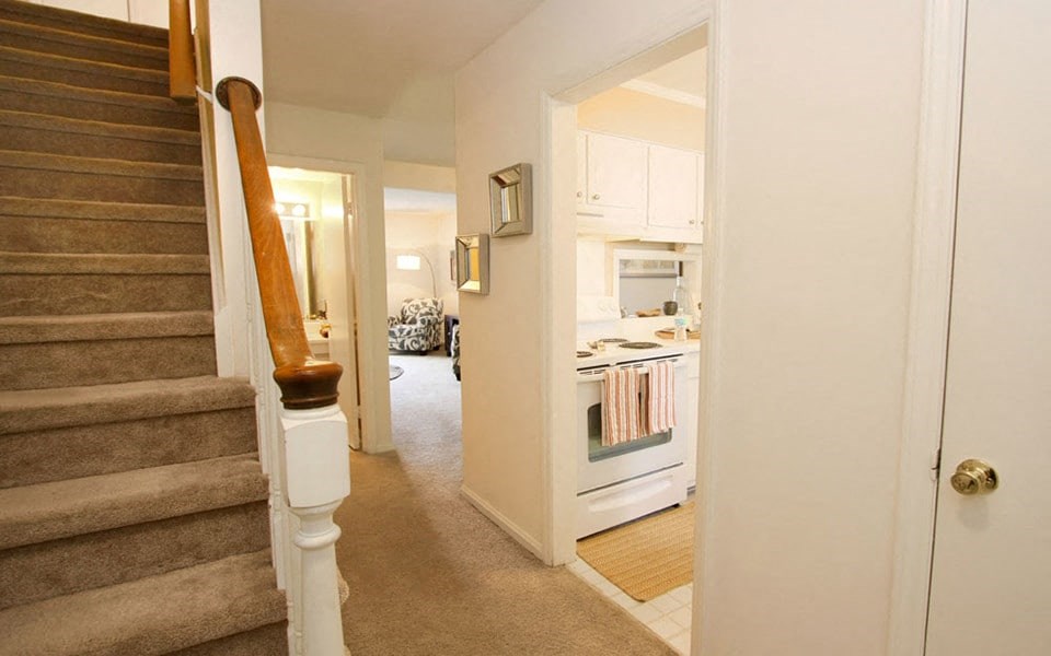 a view of a staircase and a kitchen in a home