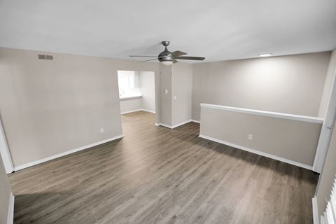 Spacious living area with ceiling fan and hardwood floors  at Huntington Apartments, North Carolina, 27560