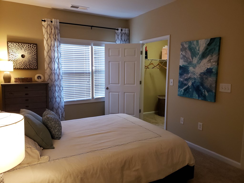 a bedroom with a bed and a door to a bathroom