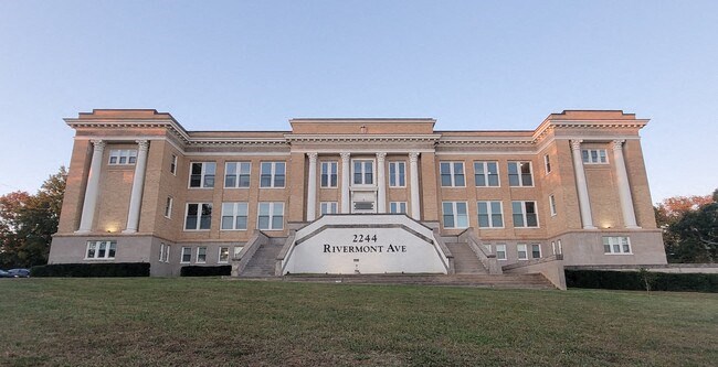 a large brick building with a sign in front of it
