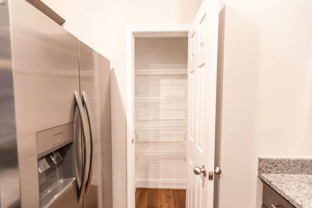 a kitchen with a refrigerator and a walk in closet