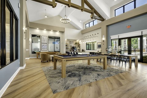 A large room with a long table and chairs.