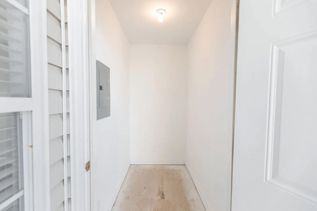 a white room with a door and a window