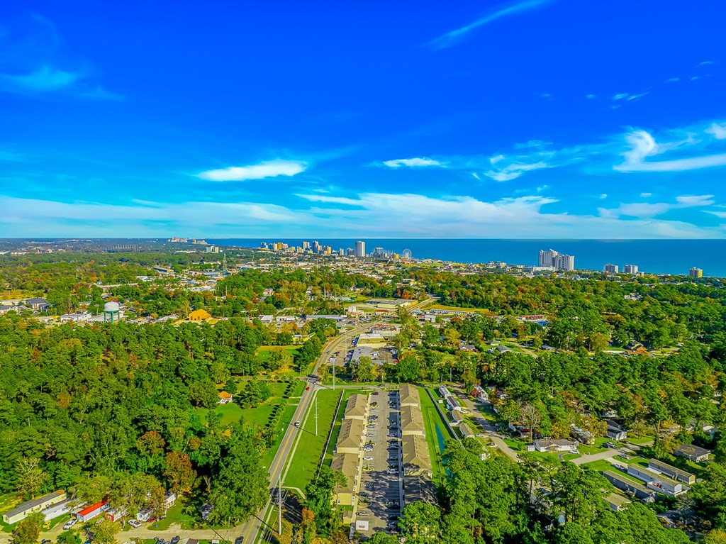 A bird's eye view of a city with a large green park in the foreground.
