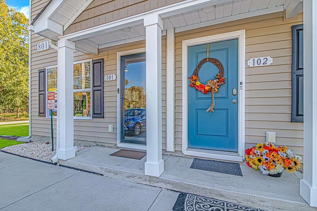 A house with a blue door and a wreath on it.