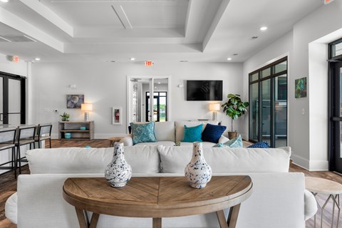 A living room with a white couch and a wooden table.