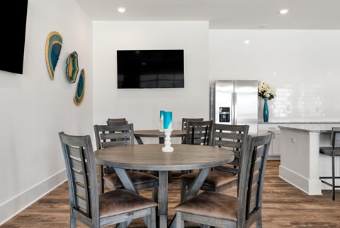 A dining room with a table and chairs.