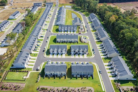A bird's eye view of a residential area with houses and roads.