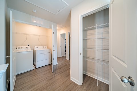 A white laundry room with a washer and dryer.