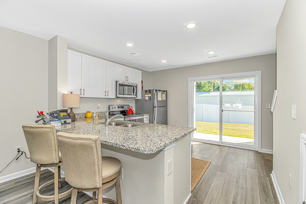 A kitchen with a granite countertop and a sink.