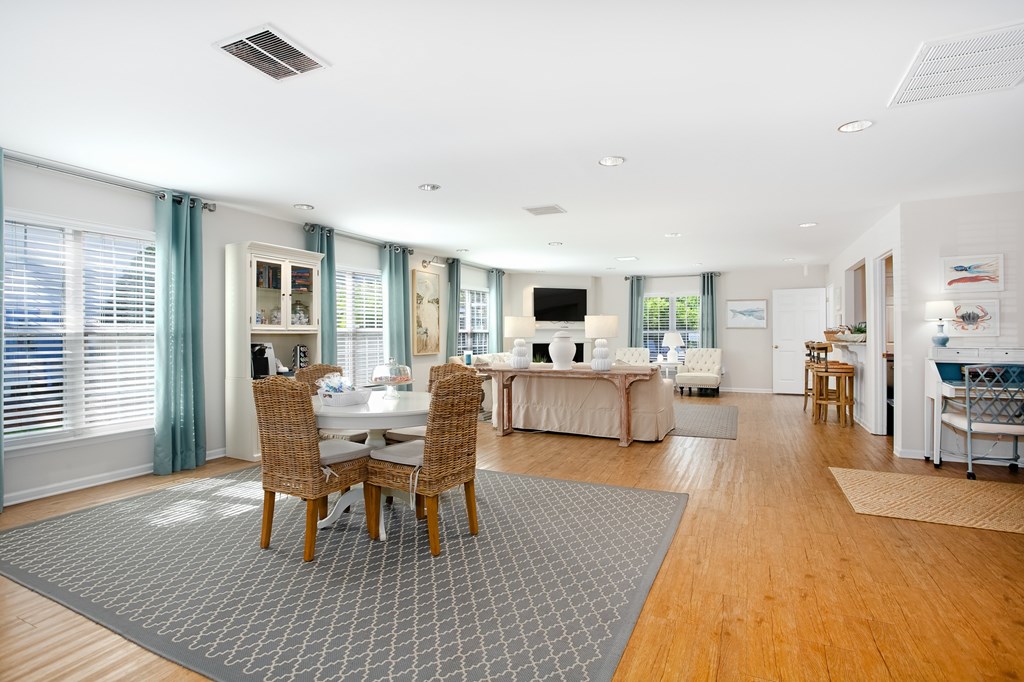 A modern dining room with a table set for four.