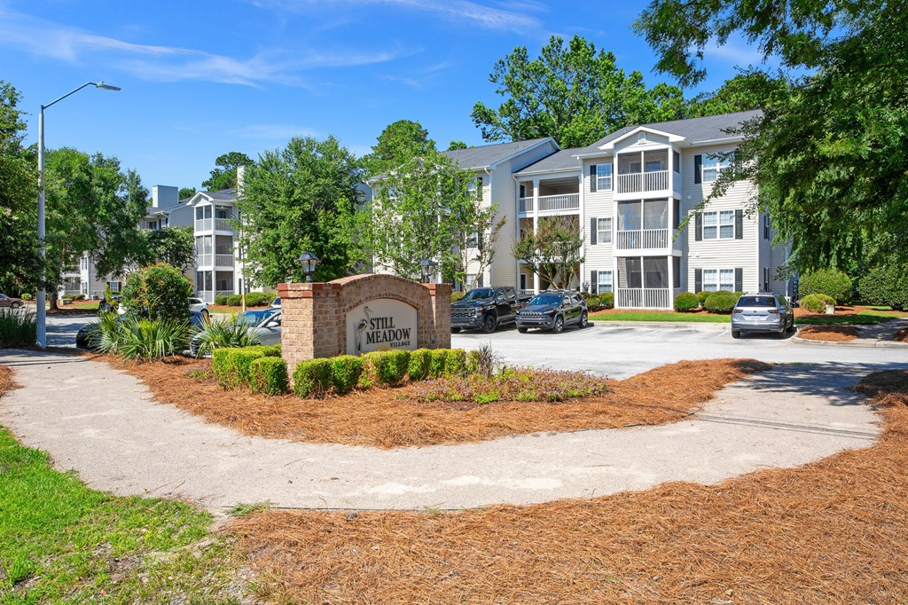 A sign that says Still Meadow in front of a building.