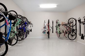 A bike rack with many bikes hanging on it.