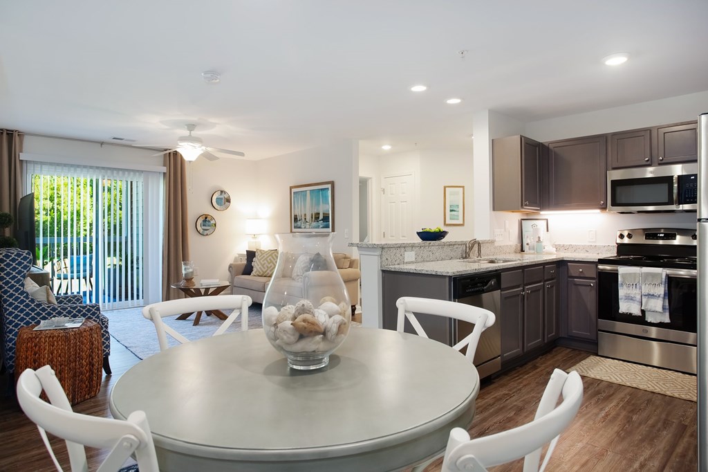 A modern kitchen with a dining table and chairs.