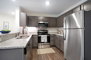 A modern kitchen with a stainless steel refrigerator.