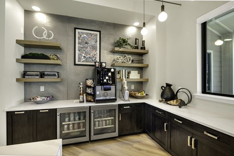 A modern kitchen with dark wood cabinets and stainless steel appliances.
