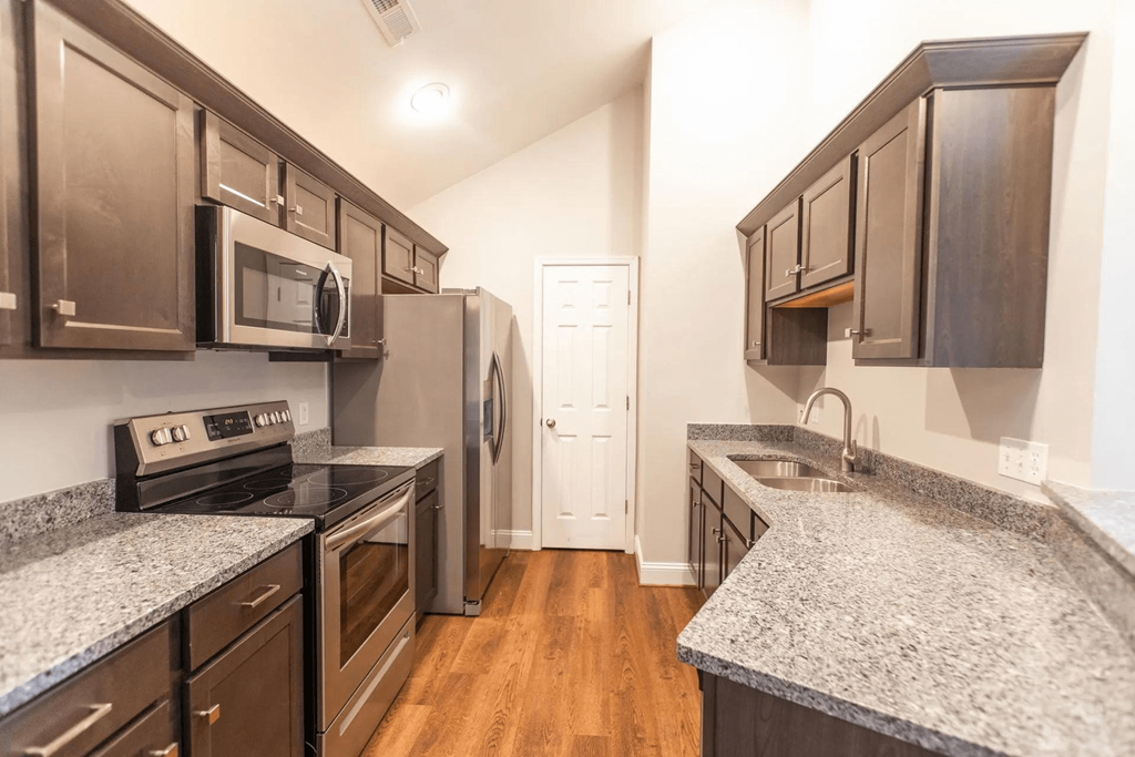 a kitchen with granite counter tops and stainless steel appliances
