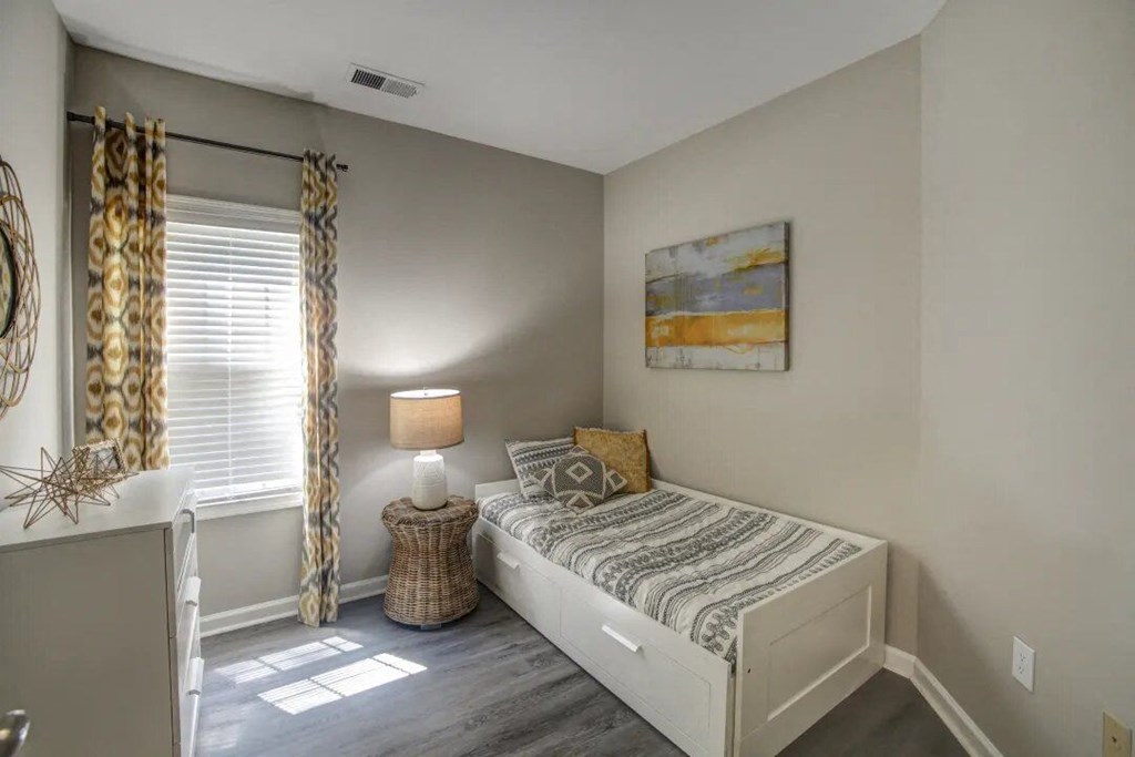 a bedroom with a bed and a window