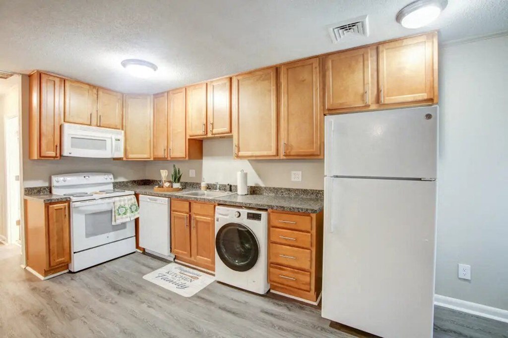 a kitchen with a stove top oven next to a refrigerator