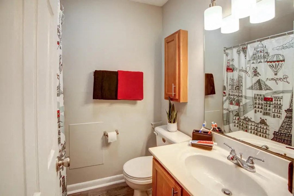 a bathroom with a sink toilet and shower