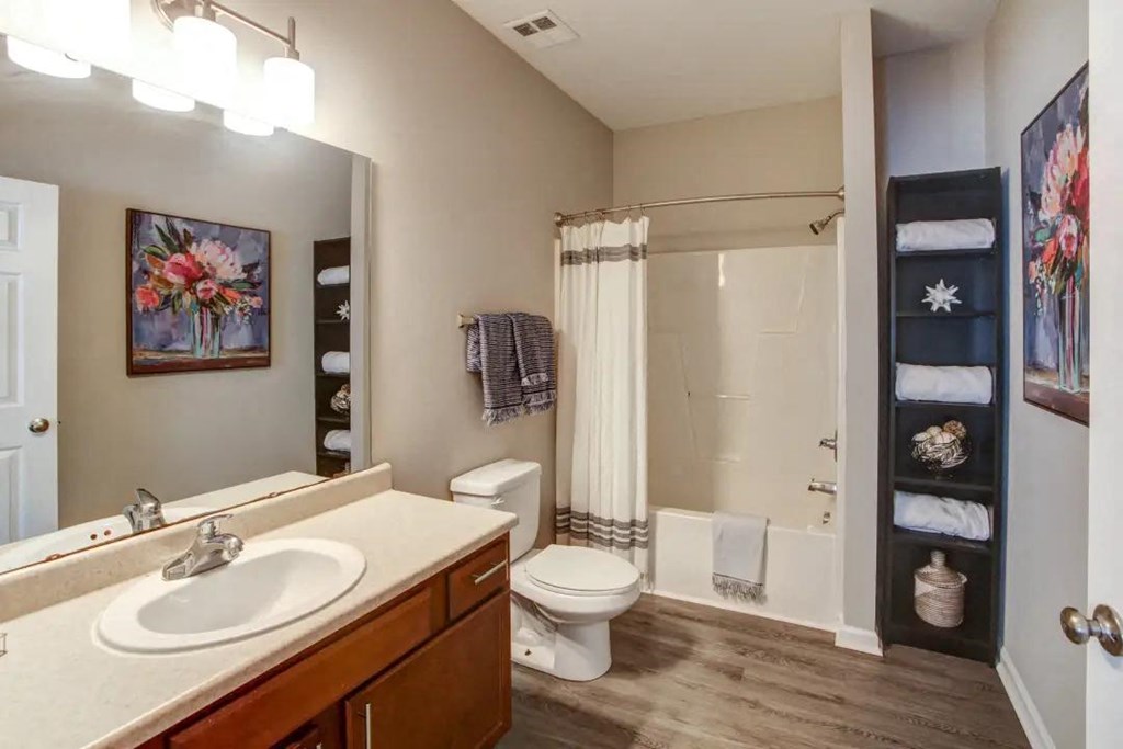 a bathroom with a sink toilet and shower