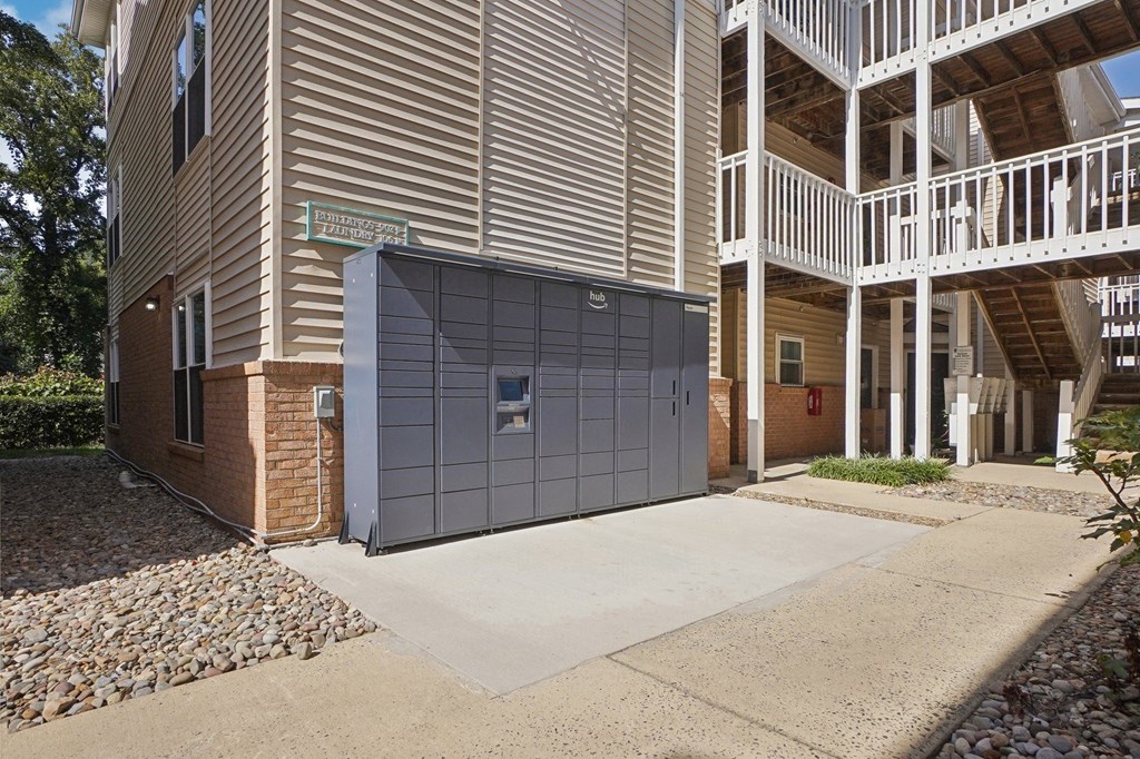 A modern building with a garage door and a balcony.