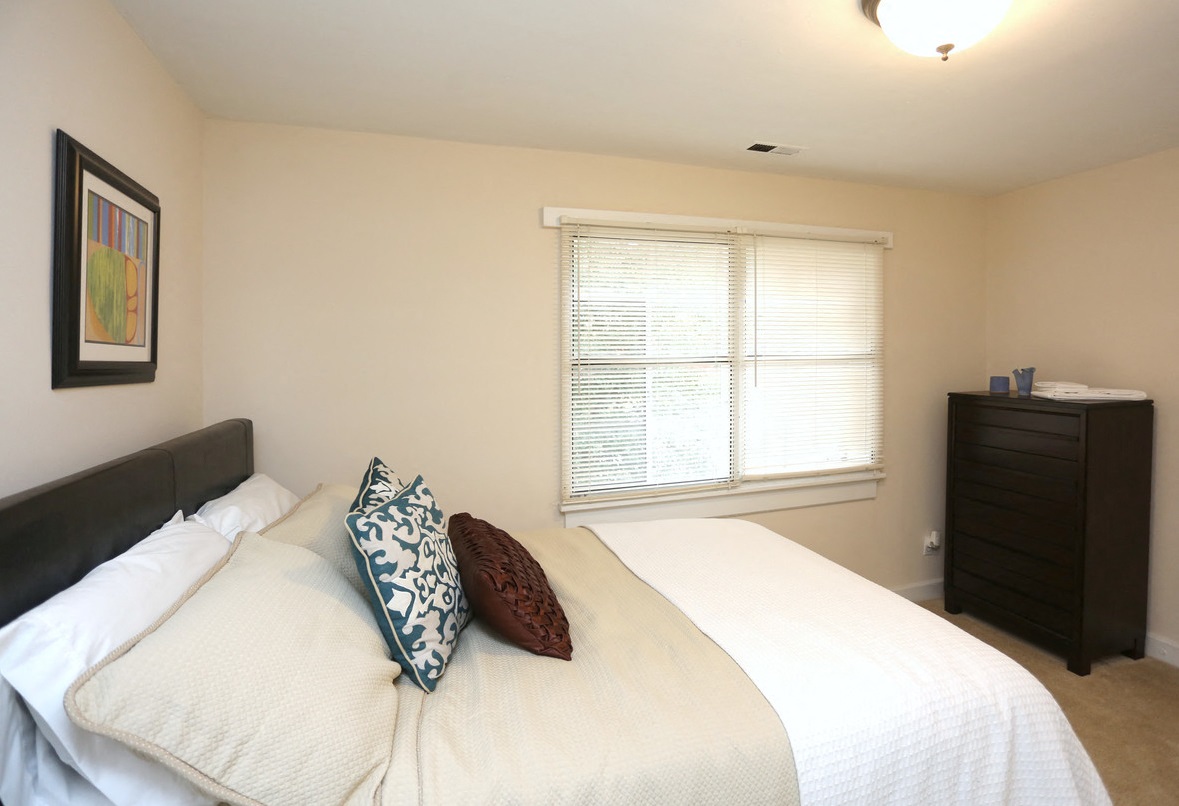 View of bedroom model with bed and dresser