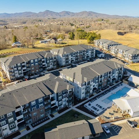 an aerial view of apartments and a swimming pool in a city