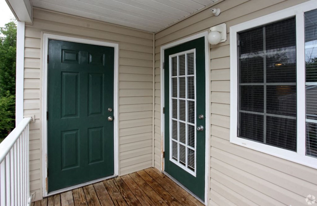 the front entrance of a home with a green door