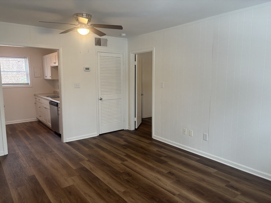 A room with wooden floors and white walls.