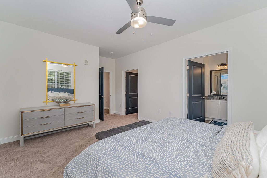 a bedroom with a large bed and a ceiling fan
