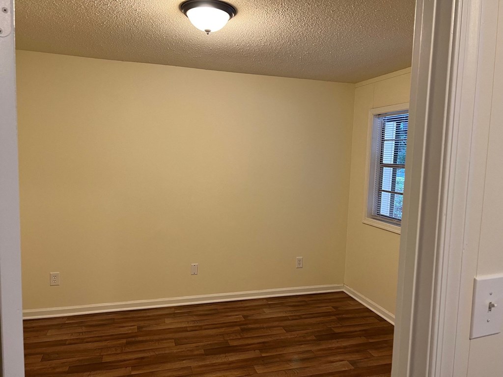 Bedroom with wood plank flooring